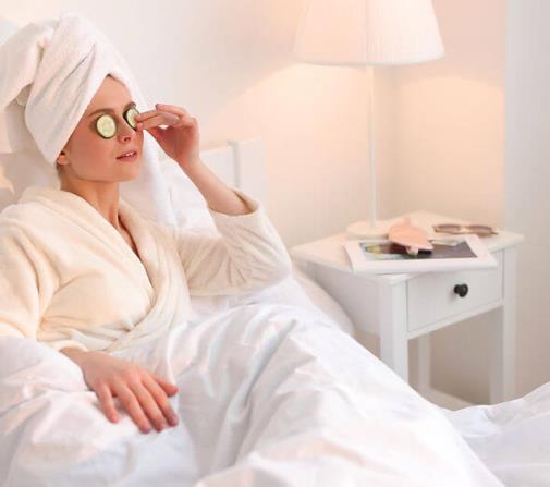 A woman bundled up in bed